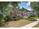Brick home with lush greenery, set on a beautifully landscaped lot in a suburban neighborhood at 250 Lawrence Pl, Atlanta, GA 30349