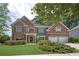 Charming two-story brick home with a well-manicured lawn and lush landscaping at 250 Lawrence Pl, Atlanta, GA 30349