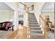 Grand foyer with hardwood floors, staircase, and open view to living areas at 250 Lawrence Pl, Atlanta, GA 30349