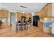 Spacious kitchen with wood floors, breakfast bar seating, and modern black appliances at 250 Lawrence Pl, Atlanta, GA 30349