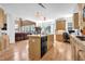 Open kitchen features a large island, wood floors, light cabinets, and adjacent living area at 250 Lawrence Pl, Atlanta, GA 30349