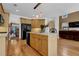 Open kitchen featuring wood cabinetry, modern appliances, an island, and an adjacent living room at 250 Lawrence Pl, Atlanta, GA 30349
