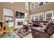 Inviting living room boasts soaring ceilings, a fireplace, and large windows that flood the space with natural light at 250 Lawrence Pl, Atlanta, GA 30349