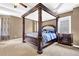 This main bedroom features a sophisticated four-poster bed, side table, and bright, neutral paint at 250 Lawrence Pl, Atlanta, GA 30349