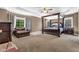 Spacious main bedroom with a four-poster bed, seating area, and plenty of natural light at 250 Lawrence Pl, Atlanta, GA 30349
