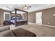 Large main bedroom boasts a stunning four-poster bed, neutral carpeting, and ample natural light from the windows at 250 Lawrence Pl, Atlanta, GA 30349