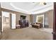 Spacious main bedroom featuring tray ceilings, a wall-mounted television, and a cozy sitting area by the window at 250 Lawrence Pl, Atlanta, GA 30349