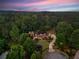 Breathtaking aerial view of a home surrounded by a mature forest at twilight at 325 Edwards Brook Ln, Canton, GA 30115