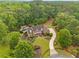 Expansive estate featuring a meticulously landscaped lawn, long driveway, and a refreshing pool at 325 Edwards Brook Ln, Canton, GA 30115