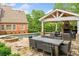 Backyard featuring a pool, a covered outdoor living area with a fireplace, and a well-designed patio for dining and relaxation at 325 Edwards Brook Ln, Canton, GA 30115