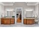 Elegant bathroom with double vanities, marble floors, and well-lit mirrors at 325 Edwards Brook Ln, Canton, GA 30115