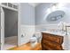 Stylish bathroom featuring a wood vanity, a unique mirror, and bright lights at 325 Edwards Brook Ln, Canton, GA 30115