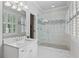 Modern bathroom featuring a glass shower with marble tiling, double windows, and a vanity sink at 325 Edwards Brook Ln, Canton, GA 30115