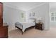 Comfortable bedroom with neutral colors, a black metal bed frame, and a nightstand at 325 Edwards Brook Ln, Canton, GA 30115