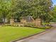 Stone community entrance sign with manicured landscaping, enhancing curb appeal at 325 Edwards Brook Ln, Canton, GA 30115