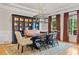 Elegant dining room with a modern chandelier, large windows, and a stylish china cabinet at 325 Edwards Brook Ln, Canton, GA 30115