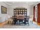 Dining room with an area rug, a modern chandelier and a large china cabinet at 325 Edwards Brook Ln, Canton, GA 30115