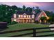 Beautiful two-story brick home with a manicured lawn, covered porch, and black shutters at 325 Edwards Brook Ln, Canton, GA 30115