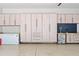 Organized garage with ample storage cabinets, epoxy flooring, and a convenient beverage station at 325 Edwards Brook Ln, Canton, GA 30115