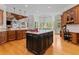 Spacious kitchen showcasing a large island, wood floors, and plenty of cabinet storage at 325 Edwards Brook Ln, Canton, GA 30115