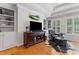 Cozy living room featuring dark wood furniture, a leather chair, and built in shelving at 325 Edwards Brook Ln, Canton, GA 30115