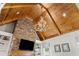 Vaulted wood ceiling with antler chandelier and stone fireplace in the living room at 325 Edwards Brook Ln, Canton, GA 30115