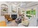 Bright living room featuring a fireplace, built-in shelves, and large windows at 325 Edwards Brook Ln, Canton, GA 30115