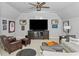 Cozy living room with a ceiling fan, comfortable seating, and sports memorabilia at 325 Edwards Brook Ln, Canton, GA 30115