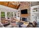 Bright living room with stone fireplace, vaulted wood ceiling, and comfortable seating area at 325 Edwards Brook Ln, Canton, GA 30115