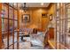 Wood-paneled office with a leather sofa and a view through glass doors at 325 Edwards Brook Ln, Canton, GA 30115