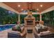 Inviting covered patio with stone fireplace, comfortable seating, and a view of the pool at 325 Edwards Brook Ln, Canton, GA 30115