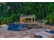 Outdoor living area with a luxurious pool, spa, covered patio, and lush landscaping at 325 Edwards Brook Ln, Canton, GA 30115