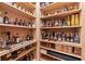 Custom wine cellar with wooden shelves filled with a large liquor selection at 325 Edwards Brook Ln, Canton, GA 30115