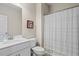 Bright bathroom with a white vanity, framed picture on wall, and shower with a decorative white curtain at 359 Crider Ct, Woodstock, GA 30188
