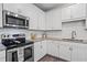 Well-appointed kitchen with granite counters, stainless steel appliances, and ample storage at 359 Crider Ct, Woodstock, GA 30188