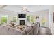 Cozy living room featuring a fireplace, large windows, and modern flooring at 359 Crider Ct, Woodstock, GA 30188