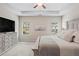 Bright main bedroom with a decorative dresser, windows offering views, and a tray ceiling at 359 Crider Ct, Woodstock, GA 30188