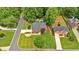 An aerial view shows the home nestled among mature trees and professionally landscaped grounds at 3987 Tamarack Nw Dr, Kennesaw, GA 30152