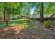 A tiered backyard offers mature landscaping and stone steps leading to the house with a covered patio at 3987 Tamarack Nw Dr, Kennesaw, GA 30152