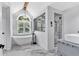 Bright bathroom showcasing a free-standing tub, a modern shower, and a vanity with marble floors at 3987 Tamarack Nw Dr, Kennesaw, GA 30152