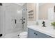 Bathroom with walk-in shower, blue vanity, white countertop and modern fixtures at 3987 Tamarack Nw Dr, Kennesaw, GA 30152