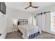 Cozy bedroom with sliding barn door, carpeted floor, and ceiling fan at 3987 Tamarack Nw Dr, Kennesaw, GA 30152