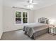 This bedroom features a ceiling fan, a large window, carpet, and a side table with lamp at 3987 Tamarack Nw Dr, Kennesaw, GA 30152