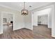Open dining room with view to living areas, modern chandelier, and trim accents at 3987 Tamarack Nw Dr, Kennesaw, GA 30152