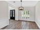 Dining room featuring hardwood floors, modern chandelier, and elegant trim work at 3987 Tamarack Nw Dr, Kennesaw, GA 30152