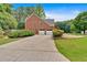 The long driveway leads to a spacious two-car garage and offers plenty of parking for guests at 3987 Tamarack Nw Dr, Kennesaw, GA 30152