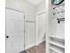 Clean entryway with coat hooks, shelving, and a view into another room at 3987 Tamarack Nw Dr, Kennesaw, GA 30152
