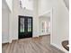 Bright foyer showcasing black framed glass doors, luxury vinyl flooring, and a view of the front yard at 3987 Tamarack Nw Dr, Kennesaw, GA 30152