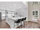 Contemporary kitchen featuring a spacious island, white cabinetry, stainless steel appliances, and hardwood flooring at 3987 Tamarack Nw Dr, Kennesaw, GA 30152