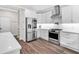 Modern kitchen with stainless steel refrigerator, white cabinets, and hardwood floors at 3987 Tamarack Nw Dr, Kennesaw, GA 30152